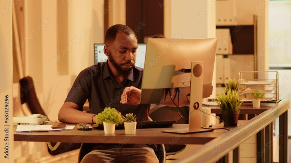 Poster male manager checking time on wristwatch and working on web presentation with online research inform