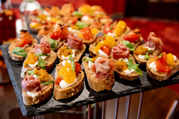 many different sandwiches with fish and vegetables on a granite stand