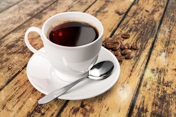A cup with tasty aroma coffee on wooden table