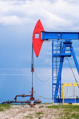 Fototapeta na wymiar Extraction of crude oil in oilfield. Oil drilling rig pumps oil.