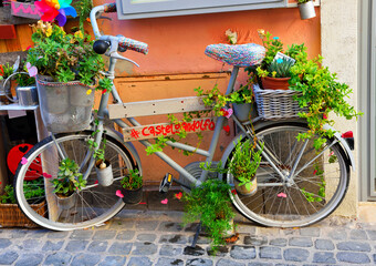 Fototapeta na wymiar bicycle as street furniture in the historic center of castel gandolfo lazio italy