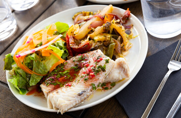 French-style molva or sea pike with vegetables. French cuisine