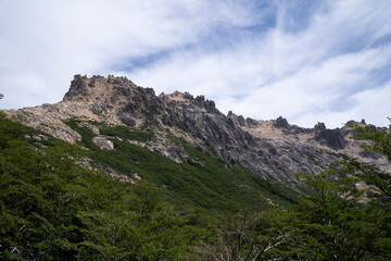 View of the green forest and rocky mountains in Catedral hill, in Bariloche, Patagonia Argentina.	