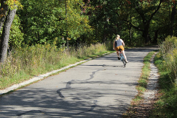 Woman swerving on her bicycle on the North Branch Trail in Morton Grove, Illinois
