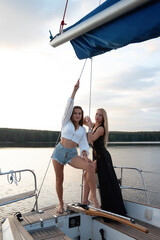 Young women on yacht at sunset