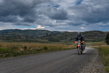 Off road motorcyclist riding on the continental Divide Ride in Colorado at dusk.  
