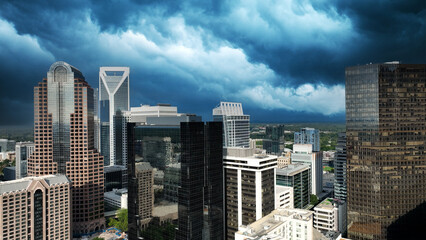 Fototapeta na wymiar Dramatic storm clouds over downtown Charlotte North Carolina. Deep blue clouds mixed with sweeping white storm clouds over city builds
