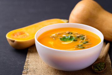 Butternut squash pumpkin soup in bowl, Homemade food in autumn season