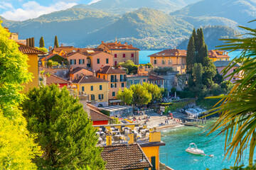 The colorful Italian lakefront village of Varenna, Italy, with tourists enjoying the cafes and...