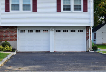 Two Car Garage a part of a single house with doors painted in white color