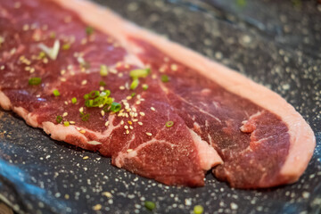 Premium rare sliced beef served for Yakiniku. Close up