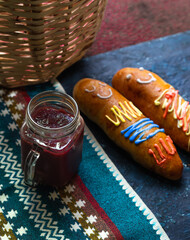 traditional ecuadorian bread and drink (guagua de pan and colada morada) for the day of the dead on...