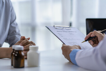 Doctors and patients sit and talk to patients about medications. At the table near the window in the hospital Consultation and advice concept