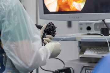 Close up photo of surgeon 's hands inside modern operating room in  surgical gown suit. Doctor...