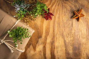 Wooden christmas background with a gift and decorations with copy space