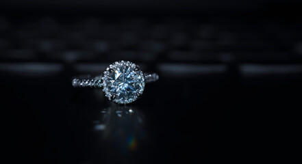A diamond ring is a glittering wedding ring placed on the ground.