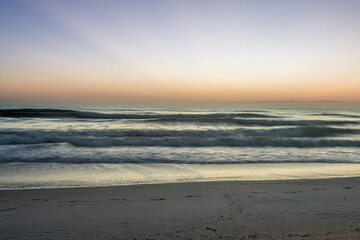 Fototapeta na wymiar Beautiful Sunrise - Long Exposure Beach waves sand