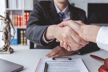 justice and law concept. male lawyer working in workplace. Legal law, advice and justice, Businessman handshake with a lawyer or judge After signing the contract and the agreement is complete, 
