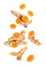 Turmeric spice with cut slices  flying in the air isolated on white background.