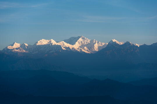 Snow capped mountain peaks in the morning light. Close up, selective focus.