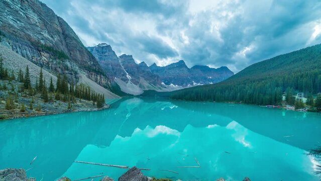 4K time-lapse UHD video of  beautiful view of an iconic famous place, Moraine Lake, a glacier lake located in Banff National Park,Alberta, Canada, in a colorful sunset cloudy summer autumn day. 