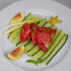 Recipe for cucumber, tomato, cebette, fig and carambola salad. High quality photo