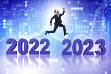 Businessman jumping from the year 2022 to 2023