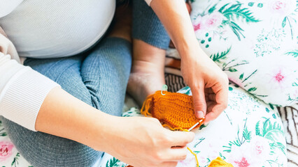 Knitting socks pregnancy woman. Pregnant mother crochet kid cloth. Cute pregnancy woman knit fashion winter baby girl clothes. Cozy knitting woman.