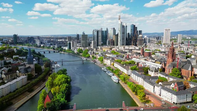 Aerial drone view of Frankfurt downtown, Germany. River Main with bridges, greenery, buildings, skyscrapers in the distance