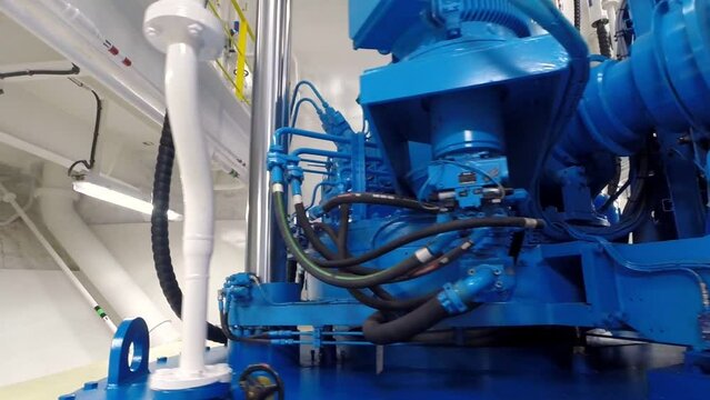 Rotating shot around a highly detailed transmission spinning in the power room of a ship