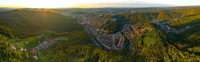 Aerial panorama view of a colorful autumn sunset in industrial city, Resita, Romania. Captured from a drone