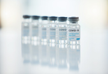 Healthcare, medicine and covid vaccine bottle, stock and product in a hospital office. Healthcare with a virus cure, wellness or corona drug in a medical research clinic for safety from covid 19