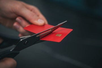 cutting a credit card with scissors. concept of crisis, stagnation, inflation.