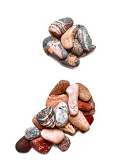 A letter of smooth stones on a white isolated background. Of the river stones lined with a letter, detailing, close-up. Selective focus
