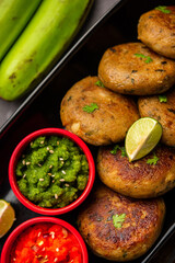 Raw Banana Cutlet also called plantain or kacche kele ki tikki or patties, served with chutney