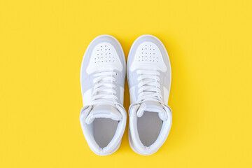 Sports shoes, sneakers with shoelaces on a yellow background. Sport lifestyle concept Top view Flat lay