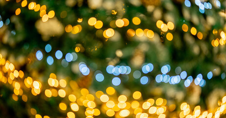 Christmas background bokeh. Christmas tree bokeh light in green yellow golden color, holiday...
