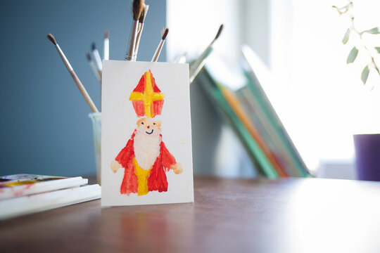 children's drawing - card for day of saint nicholas on table background for traditional Dutch holiday sinterklaas. craft for kids