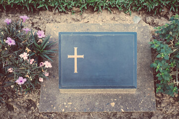 Top view of grave with no inscription unknown soldier with peaceful and tranquil down in cemetery graveyard. Shot of gravestone in churchyard. Concept of Halloween season design with copy space