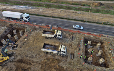 Aerial view of large construction site with several earthmover machines