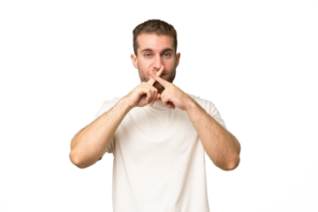 Young handsome caucasian man isolated on green chroma background showing a sign of silence gesture