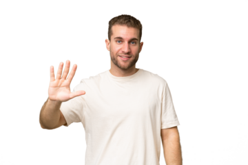 Young handsome caucasian man isolated on green chroma background counting five with fingers