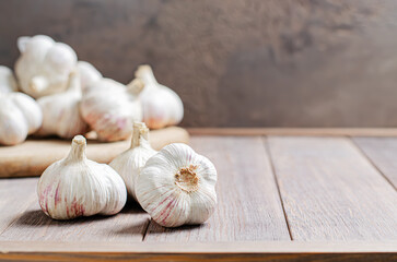 Garlic bulbs on a wooden background. Copy space.