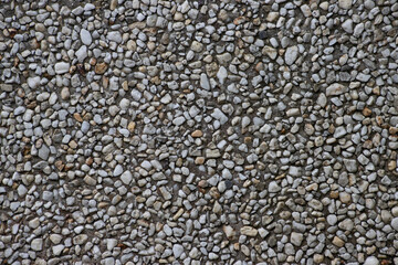 Small pebbles in concrete wall for background
