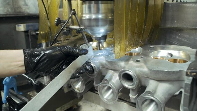 Close up shot of morning machine cutting car cylinder heads valve seats. Cinematic slow motion with smooth camera rotation.