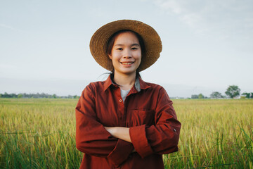 Farmers smile and cross arms in a field and happy harvesting rice in rural Thailand. Asian farmers. Agriculture concept. farmers of Thailand