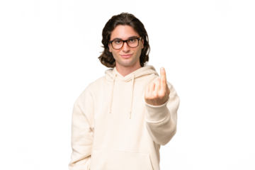 Young caucasian man isolated on green chroma background doing coming gesture