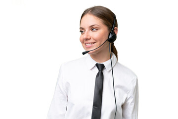Telemarketer caucasian woman working with a headset over isolated background with happy expression
