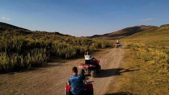 Aerial View From Behind ATVs by Lake and Mountain