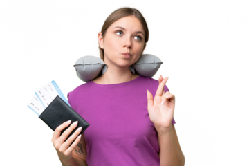 Young beautiful blonde woman with Inflatable travel Pillow over isolated background with fingers crossing and wishing the best